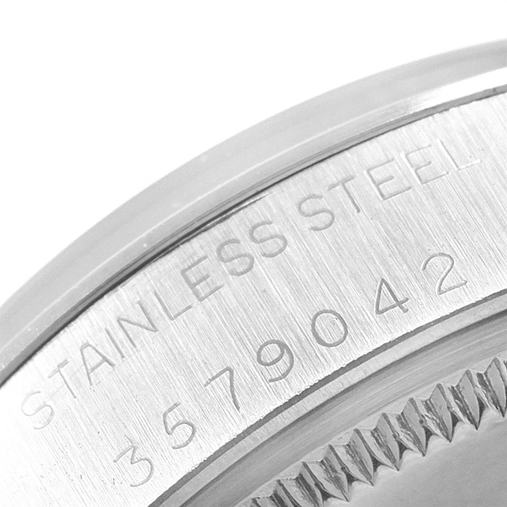 This close-up image shows the case back of the Vintage Collection model by Rolex, highlighting its stainless steel inscription and serial number.