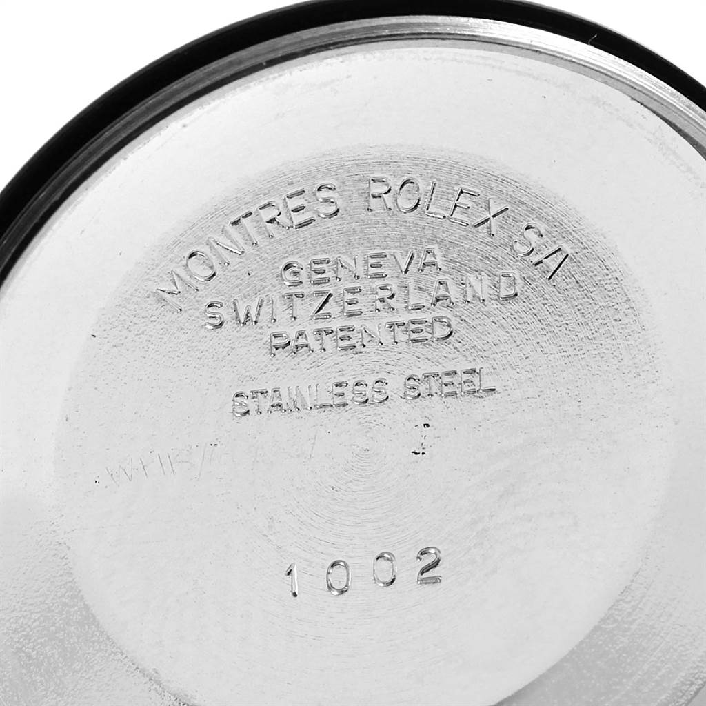 The image shows the inner side of the case back of a Vintage Collection model by Rolex, highlighting its inscriptions and stainless steel material.