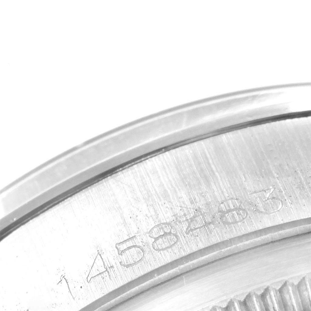The image shows a close-up of the engraved casing, featuring its serial number, on a Rolex Vintage Collection 1500 Men's Stainless Steel Silver Dial 1500 Men's Stainless Steel Silver Dial model.