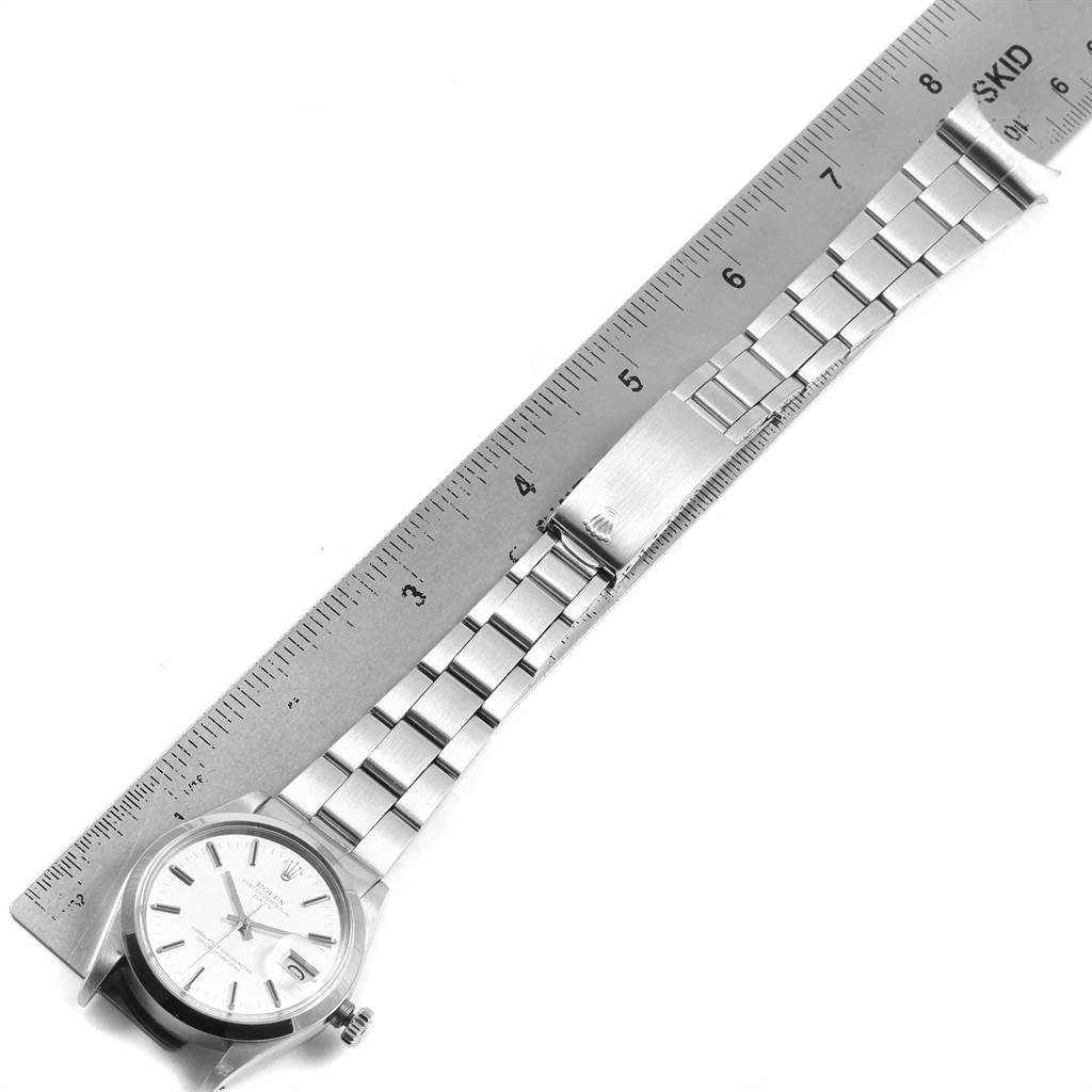 The image shows a Rolex Vintage Collection 1500 Men's Stainless Steel Silver Dial 1500 Men's Stainless Steel Silver Dial model watch laid flat with a ruler indicating the length of its stainless steel bracelet.