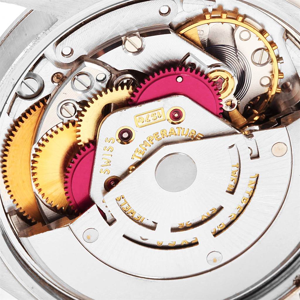 This close-up angle shows the internal mechanical movement parts of the Rolex Vintage Collection 1500 Men's Stainless Steel Silver Dial 1500 Men's Stainless Steel Silver Dial watch, highlighting gears and components.