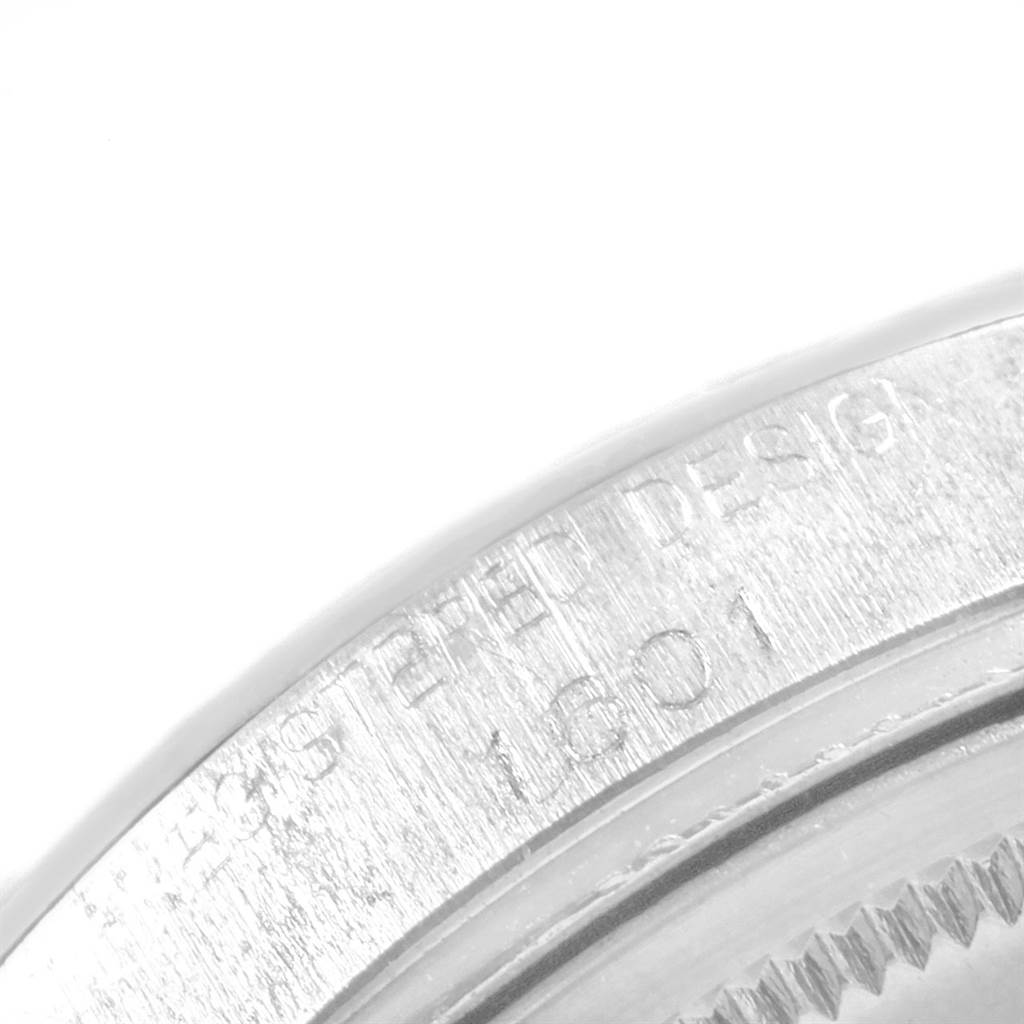 The image shows a close-up of the serial number engraving on the bezel of a Rolex Vintage Collection 1601 Men's Stainless Steel Silver Dial 1601 Men's Stainless Steel Silver Dial watch.
