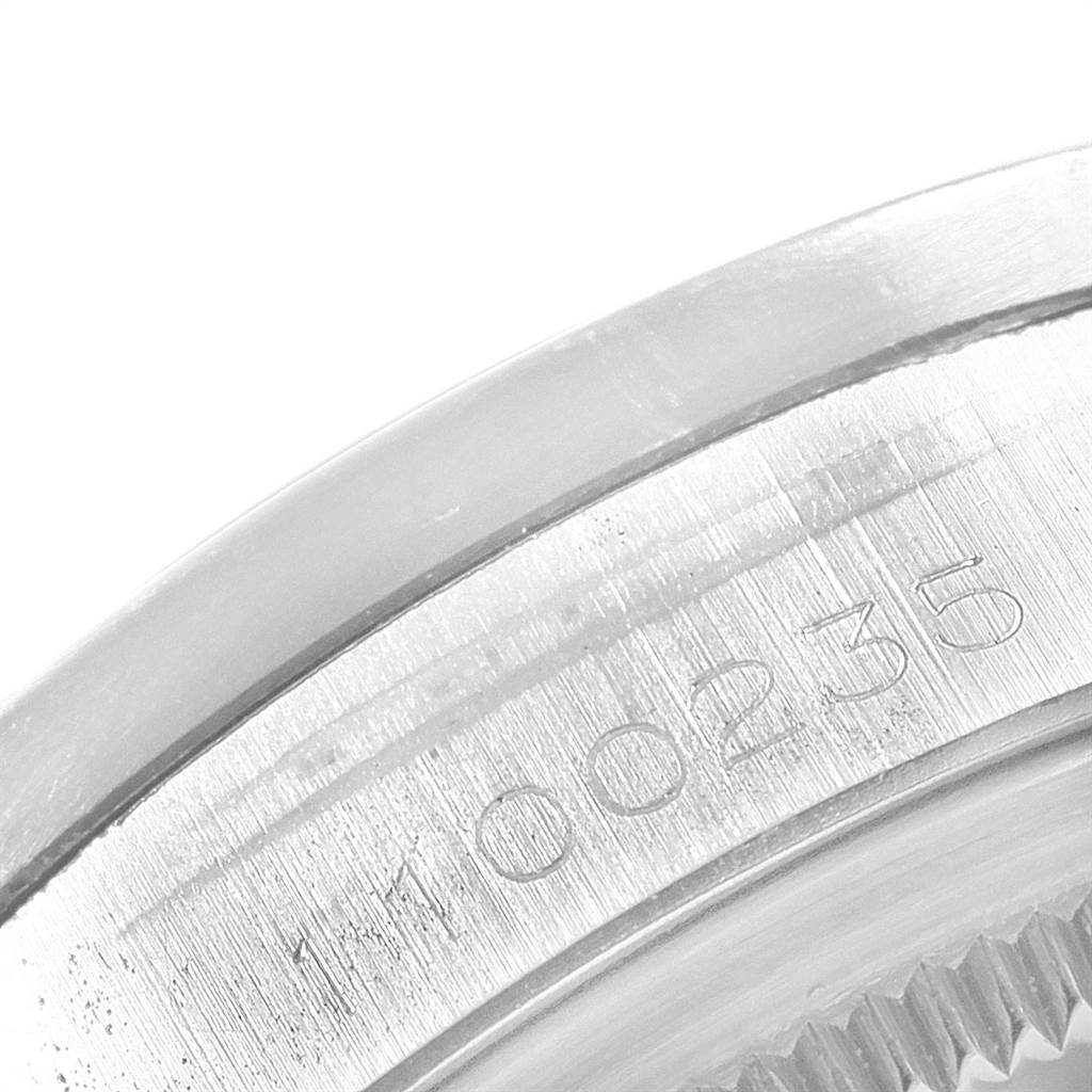 The image shows a close-up of the serial number on the edge of a Rolex Vintage Collection 1501 Men's Stainless Steel Silver Dial 1501 Men's Stainless Steel Silver Dial watch case.