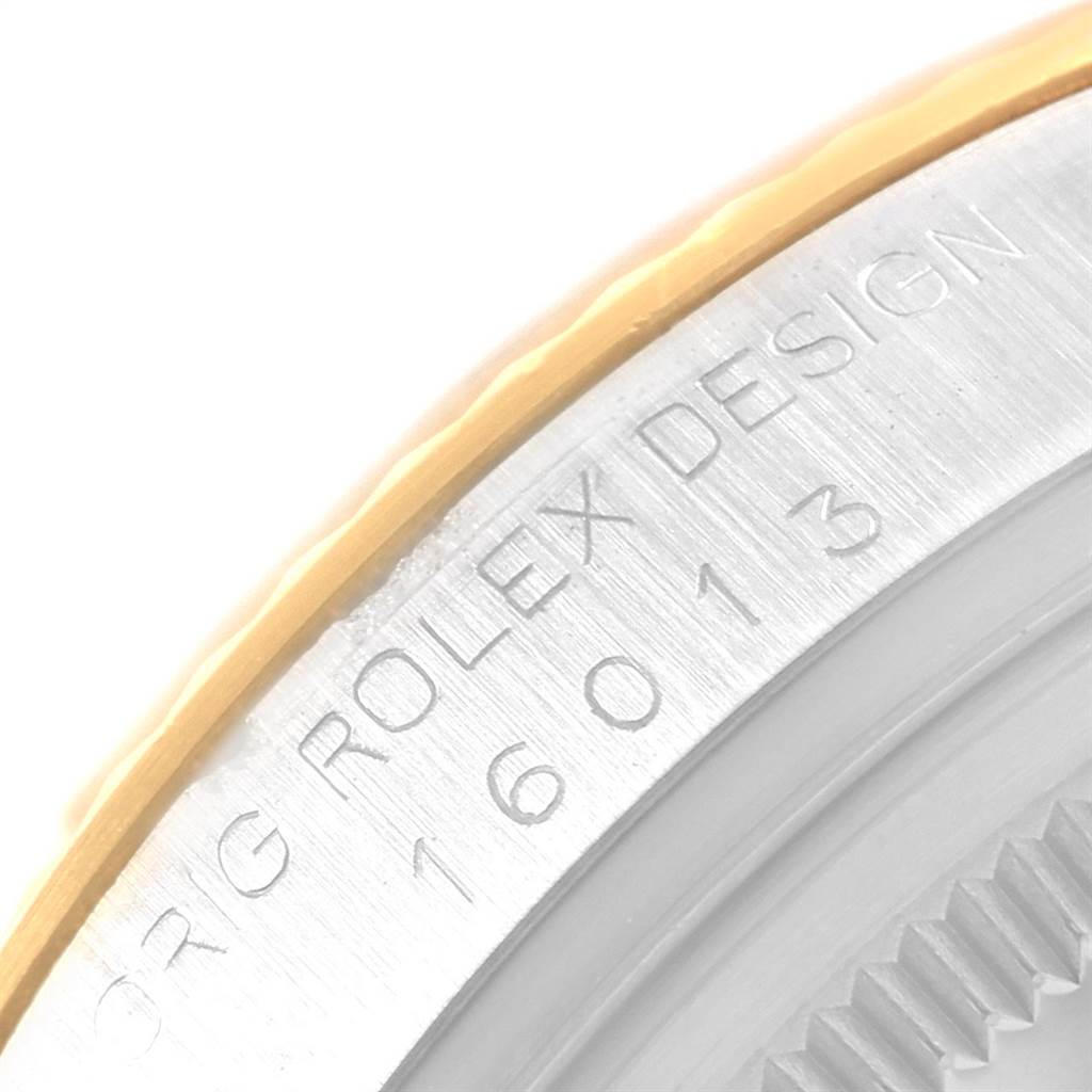 This image shows a close-up detail of the side of a Rolex Vintage Collection 16013 Men's Stainless Steel Champagne Dial 16013 Men's Stainless Steel Champagne Dial watch, highlighting the engraved text and serial number.