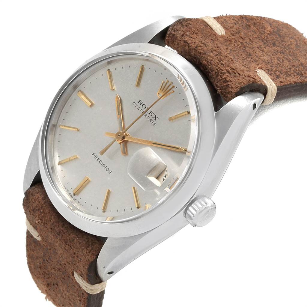 The image shows a close-up side view of the Rolex Vintage Collection 6694 Men's Stainless Steel Silver Dial 6694 Men's Stainless Steel Silver Dial watch, focusing on its dial, case, crown, and leather strap.