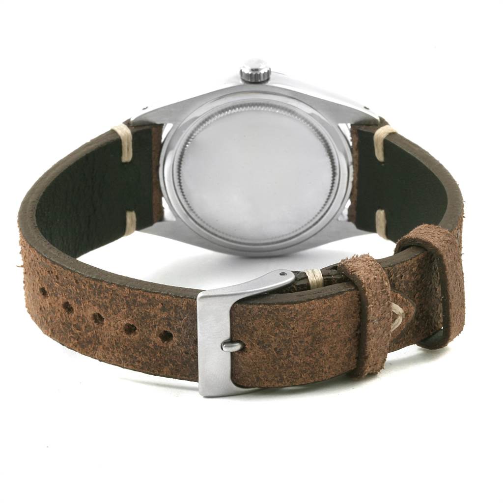 This image shows the back view of a Rolex Vintage Collection 6694 Men's Stainless Steel Silver Dial 6694 Men's Stainless Steel Silver Dial watch, highlighting its leather strap and buckle.