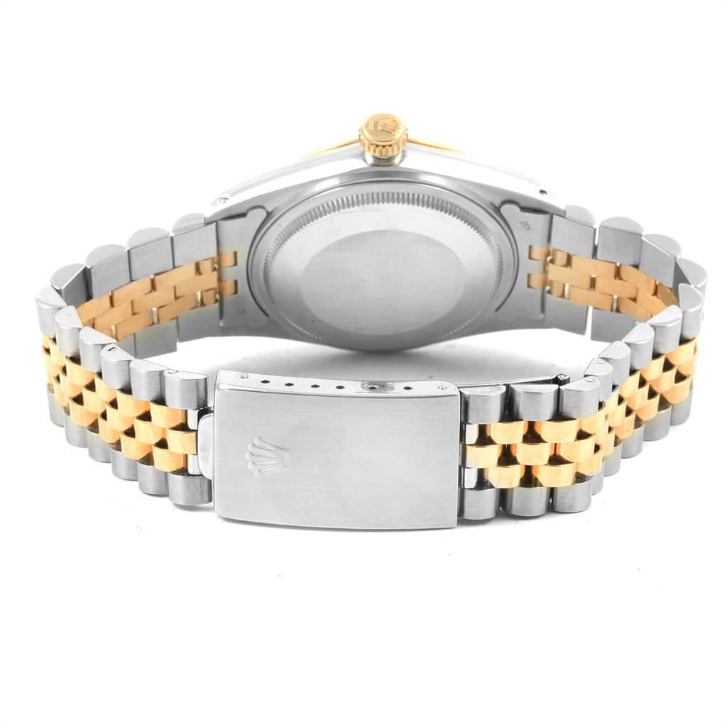 This image shows the rear view of a Rolex Vintage Collection 16013 Men's Stainless Steel Champagne Dial 16013 Men's Stainless Steel Champagne Dial model with its silver and gold bracelet and clasp visible.