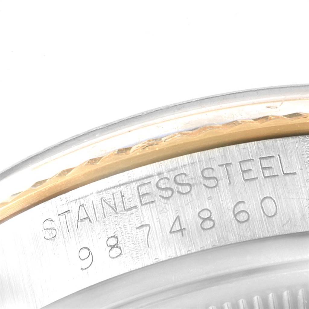 This close-up image shows the serial number and "Stainless Steel" engraving on the case edge of a Rolex Vintage Collection 16013 Men's Stainless Steel Champagne Dial 16013 Men's Stainless Steel Champagne Dial watch.
