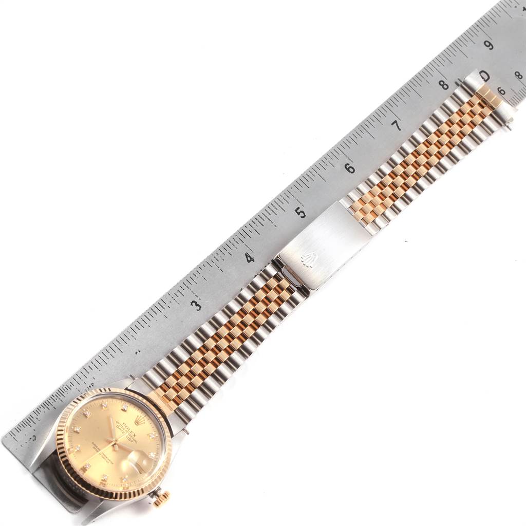 The image shows a Rolex Vintage Collection 16013 Men's Stainless Steel Champagne Dial 16013 Men's Stainless Steel Champagne Dial watch lying flat next to a ruler, displaying the face, bracelet, and clasp.