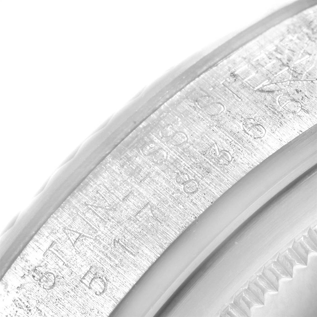 This close-up angle of the Rolex Vintage Collection 1601 Men's Stainless Steel Blue Dial 1601 Men's Stainless Steel Blue Dial watch shows part of the engraved casing and bezel.