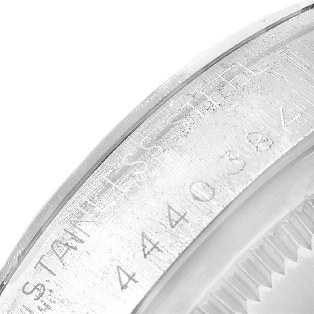 The image shows a close-up of the engraved stainless steel case back of a Vintage Collection model watch by Rolex.