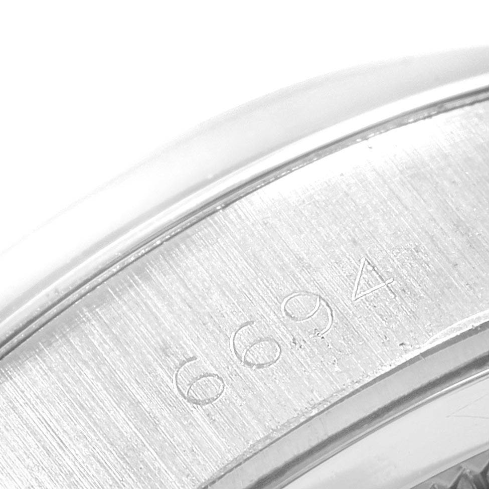 This image shows a close-up of the serial number engraving on the case of a Rolex Vintage Collection 6694 Men's Stainless Steel Black Dial 6694 Men's Stainless Steel Black Dial model watch.