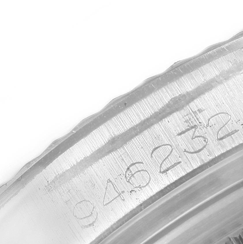 This image shows a close-up of the engraved serial number on the case of a Vintage Collection model by Rolex.