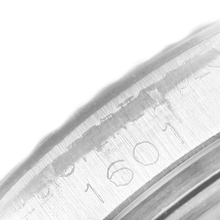 This close-up image shows the engraved bezel and part of the serial number on a Rolex Vintage Collection 1601 Men's Stainless Steel Silver Dial 1601 Men's Stainless Steel Silver Dial watch.