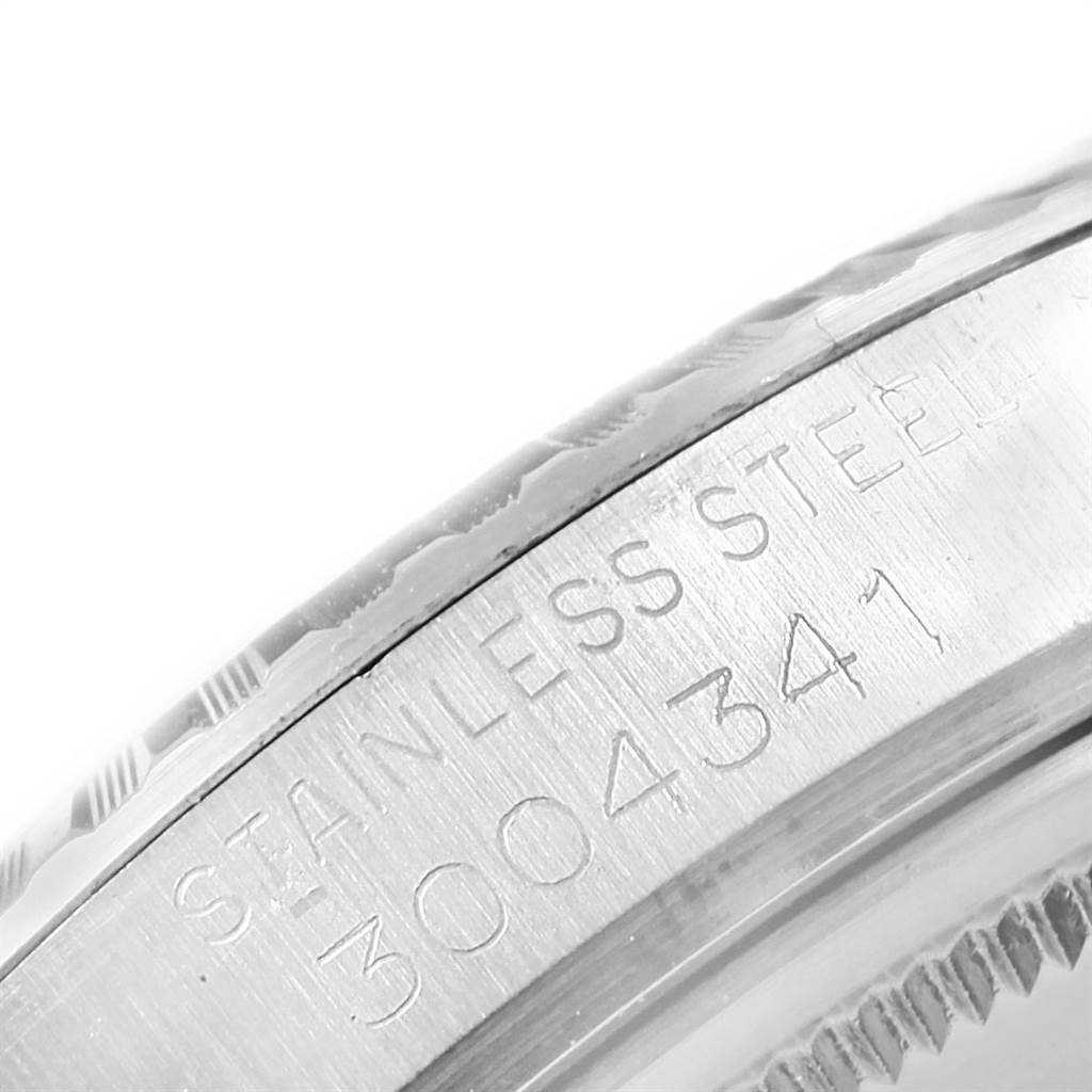This image shows a close-up of the side of a Rolex Vintage Collection 1603 Men's Stainless Steel Silver Dial 1603 Men's Stainless Steel Silver Dial model watch, featuring the engraved serial number and stainless steel marking.