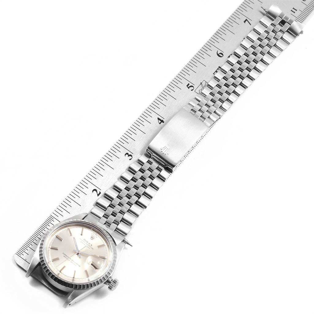 The Rolex Vintage Collection 1603 Men's Stainless Steel Silver Dial 1603 Men's Stainless Steel Silver Dial model watch is shown from a top-down angle, highlighting its face, bezel, bracelet, and clasp measured against a ruler.