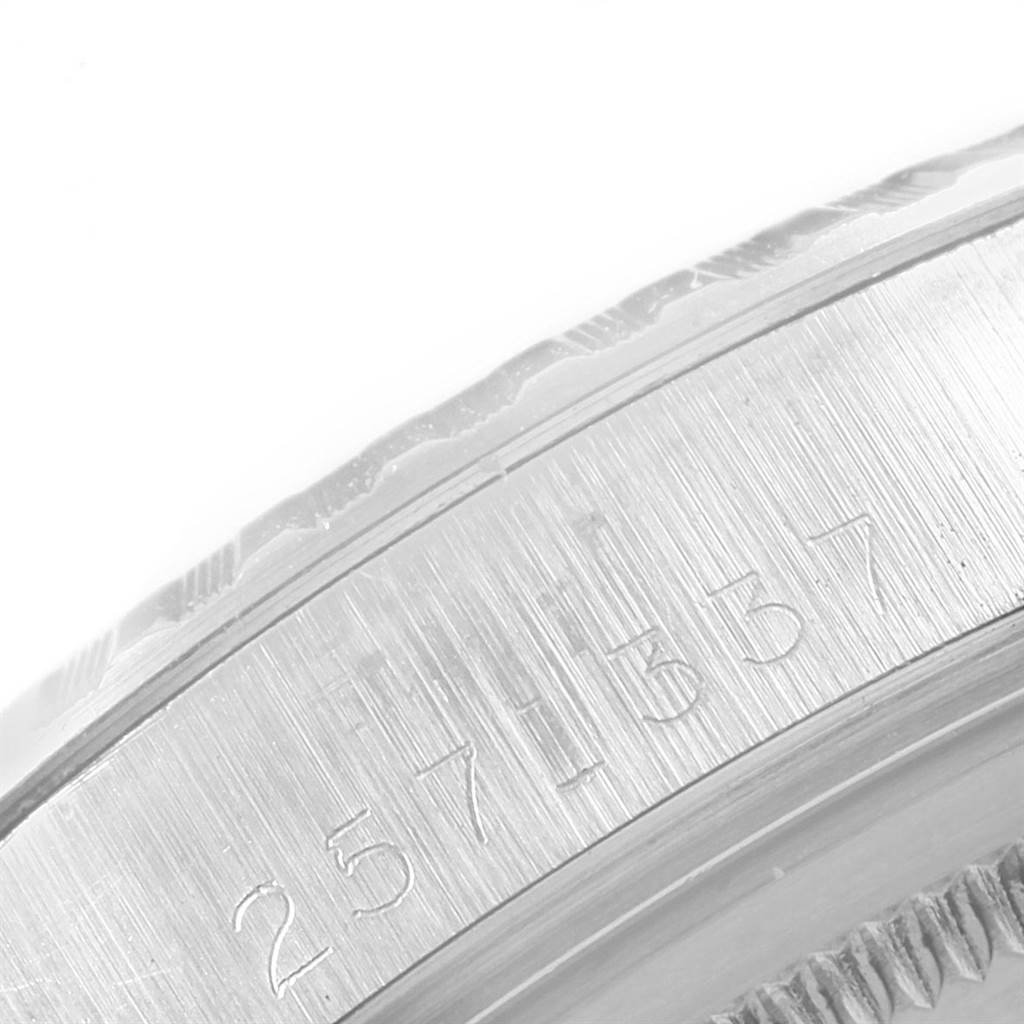This image shows a close-up of the engraved serial number on the bezel of a Vintage Collection Rolex watch.