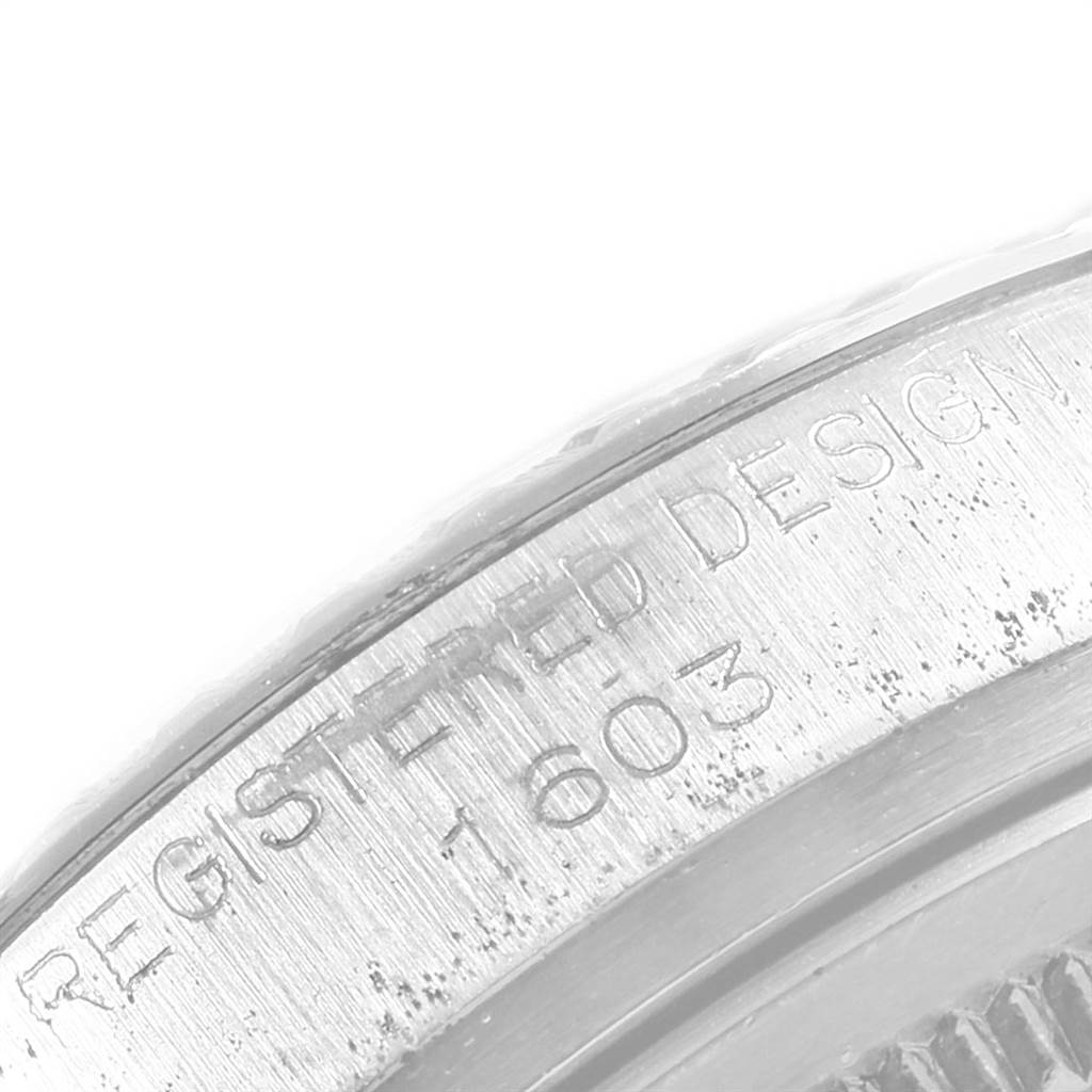 This image shows a close-up of the engraved serial number "1603" on the case of a Vintage Collection model by Rolex.
