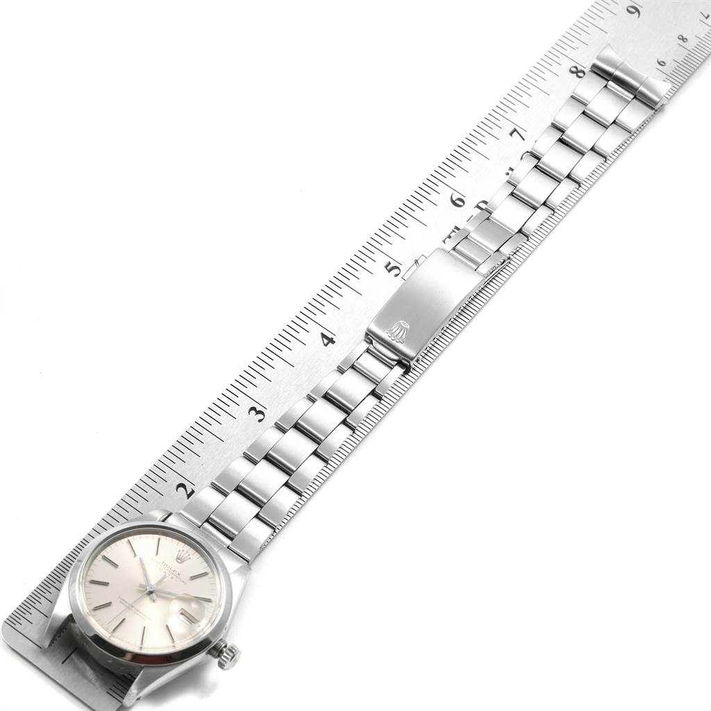 The Rolex Vintage Collection 1500 Men's Stainless Steel Silver Dial 1500 Men's Stainless Steel Silver Dial watch is shown from the top, displaying the face, metal strap, and clasp beside a ruler for measurement.