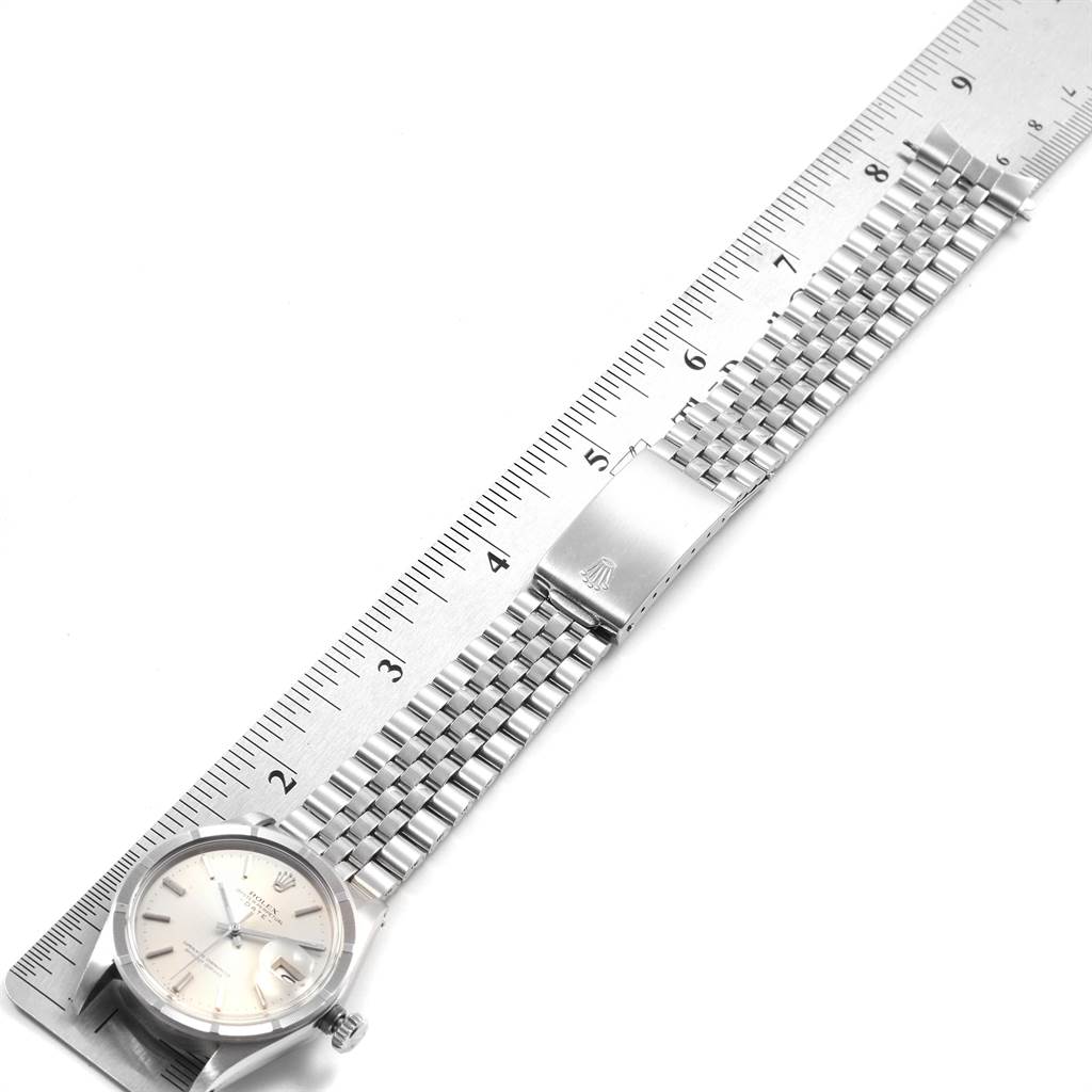 This image shows a top view of the Rolex Vintage Collection 1501 Men's Stainless Steel Silver Dial 1501 Men's Stainless Steel Silver Dial watch, aligning with a ruler to display its band length and clasp detail.