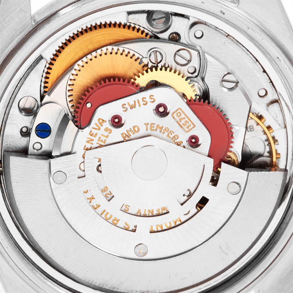 The image shows a close-up of the internal mechanism of a Vintage Collection Rolex watch, highlighting its gears and components.