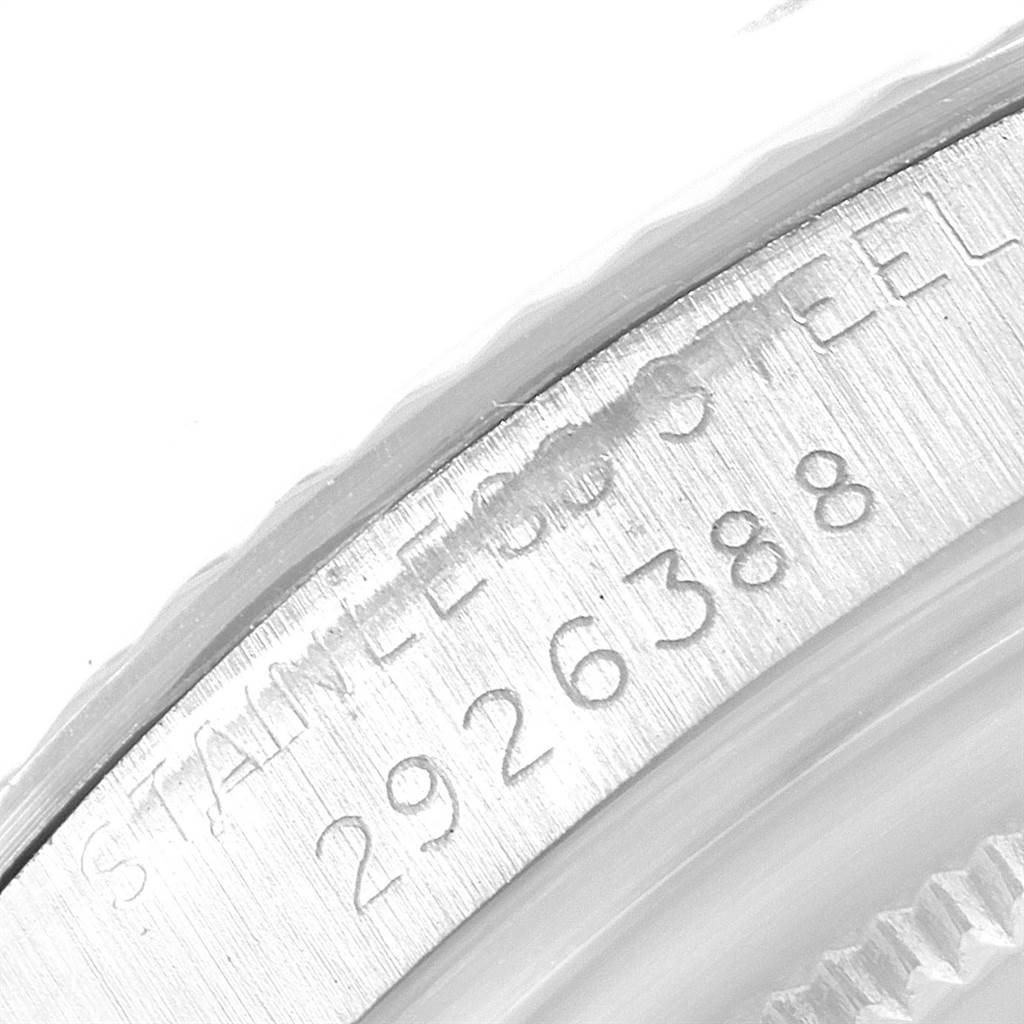 The image shows a close-up of the serial number and "STAINLESS STEEL" engraving on the casing of a Vintage Collection model by Rolex.