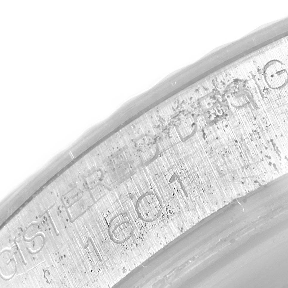 The image shows a close-up view of the outer edge of the Rolex Vintage Collection 1601 Men's Stainless Steel Silver Dial 1601 Men's Stainless Steel Silver Dial watch case, featuring inscribed text.