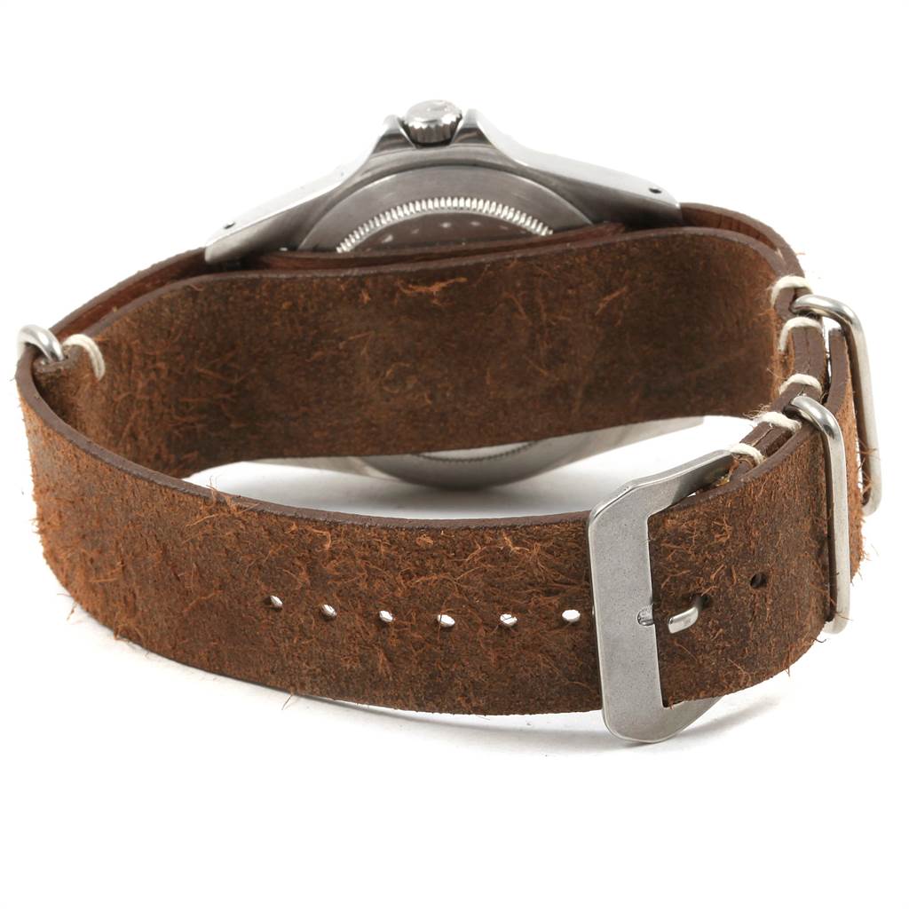 The Vintage Collection Rolex watch is shown from the back, highlighting its leather strap and stainless steel casing.