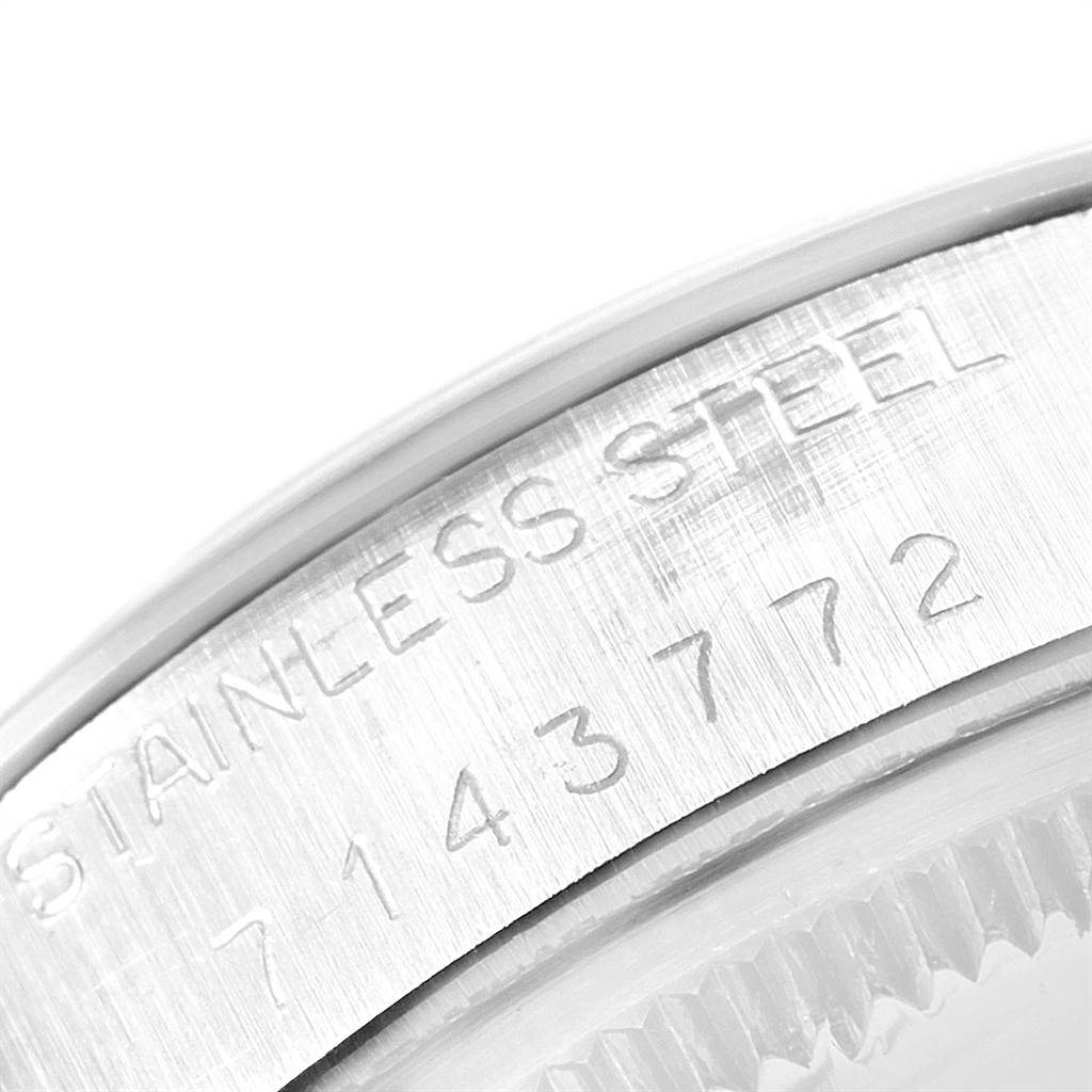 This image shows a close-up of the serial number and "Stainless Steel" engraving on the case of a Vintage Collection Rolex watch.