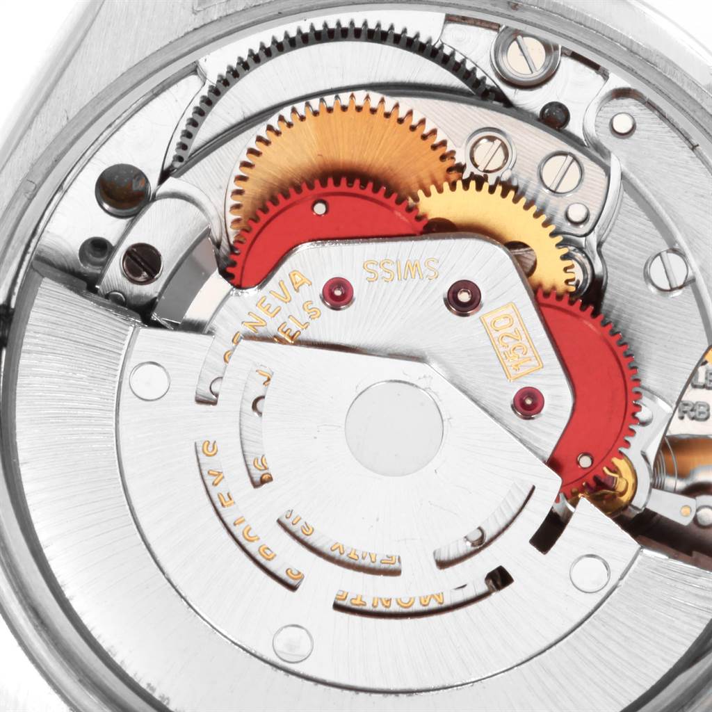 The image shows a close-up of the internal mechanism of a Vintage Collection model by Rolex, highlighting the gears and components.