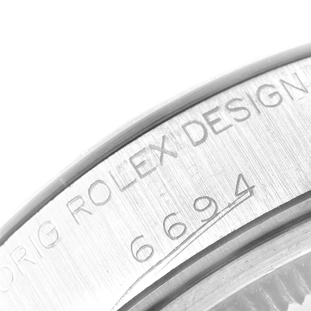 The image shows a close-up of the side of the Rolex Vintage Collection 6694 Men
s Stainless Steel Silver Dial 6694 Men
s Stainless Steel Silver Dial model, featuring the engraved design number "6694".