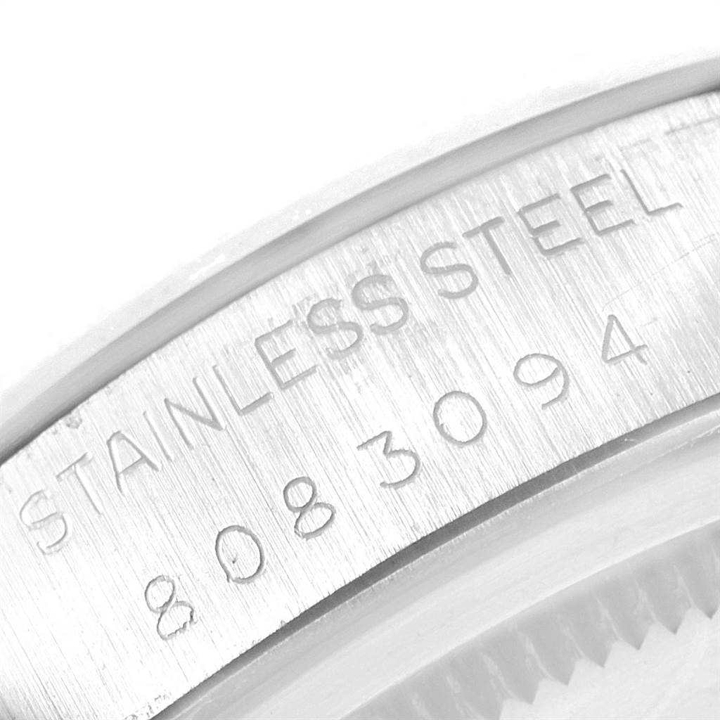 This image shows a close-up view of the stainless steel case back on a Vintage Collection Rolex watch, displaying part of the serial number.