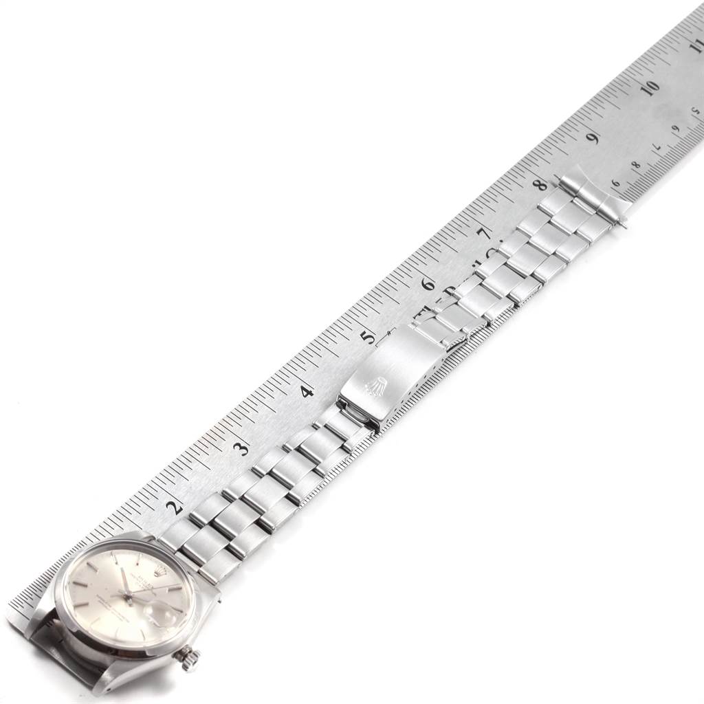 The image shows a Rolex Vintage Collection 1500 Men
s Stainless Steel Silver Dial 1500 Men
s Stainless Steel Silver Dial watch laid flat beside a ruler, displaying the face, bracelet, and clasp.