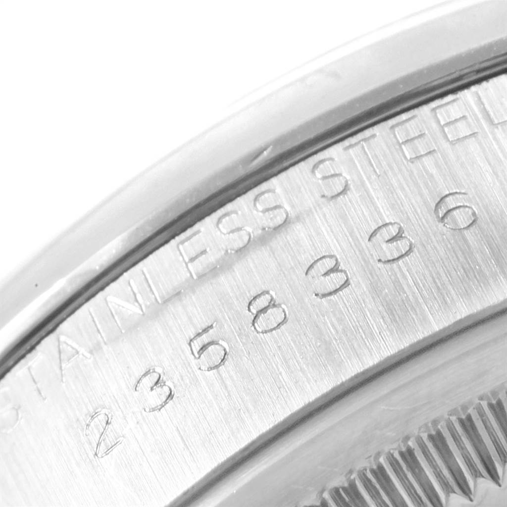 This image shows a close-up of the side of a stainless steel Rolex Vintage Collection 1500 Men
s Stainless Steel Silver Dial 1500 Men
s Stainless Steel Silver Dial watch, showing its serial number and some bezel details.