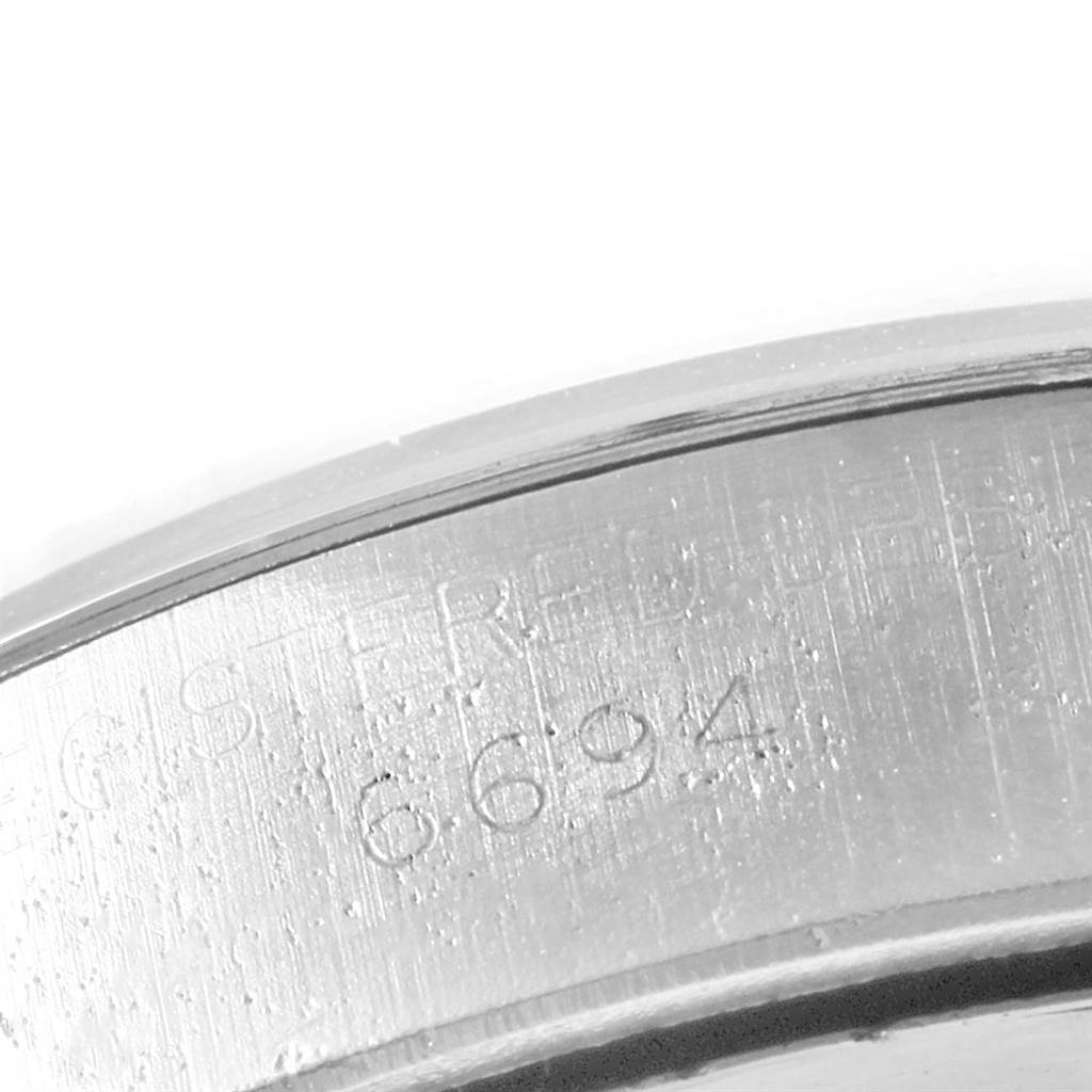This close-up image shows the engraved serial number on the edge of the Rolex Vintage Collection 6694 Men
s Stainless Steel Silver Dial 6694 Men
s Stainless Steel Silver Dial watch case.