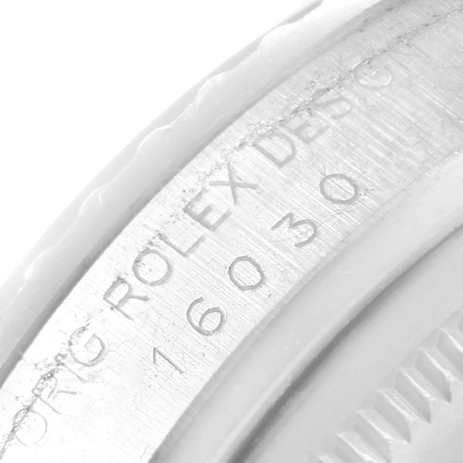 This close-up image shows the engraved serial number and part of the bezel of a Vintage Collection Rolex watch.