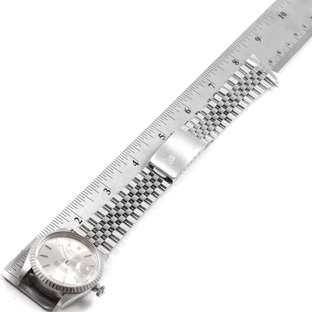 This is a top view of a Rolex Vintage Collection 16030 Men
s Stainless Steel Silver Dial 16030 Men
s Stainless Steel Silver Dial watch showing its silver bracelet measured against a ruler.