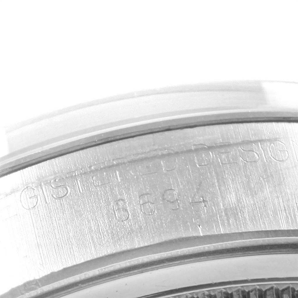 This close-up image shows the engraved side of a Rolex Vintage Collection 6694 Men
s Stainless Steel Silver Dial 6694 Men
s Stainless Steel Silver Dial watch case, highlighting the model details.