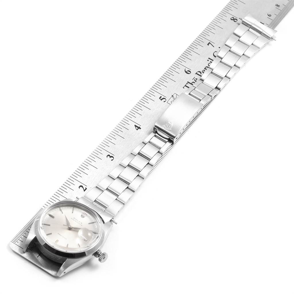 The Vintage Collection Rolex watch is shown at a top-down angle, displaying the watch face, bracelet, and clasp.