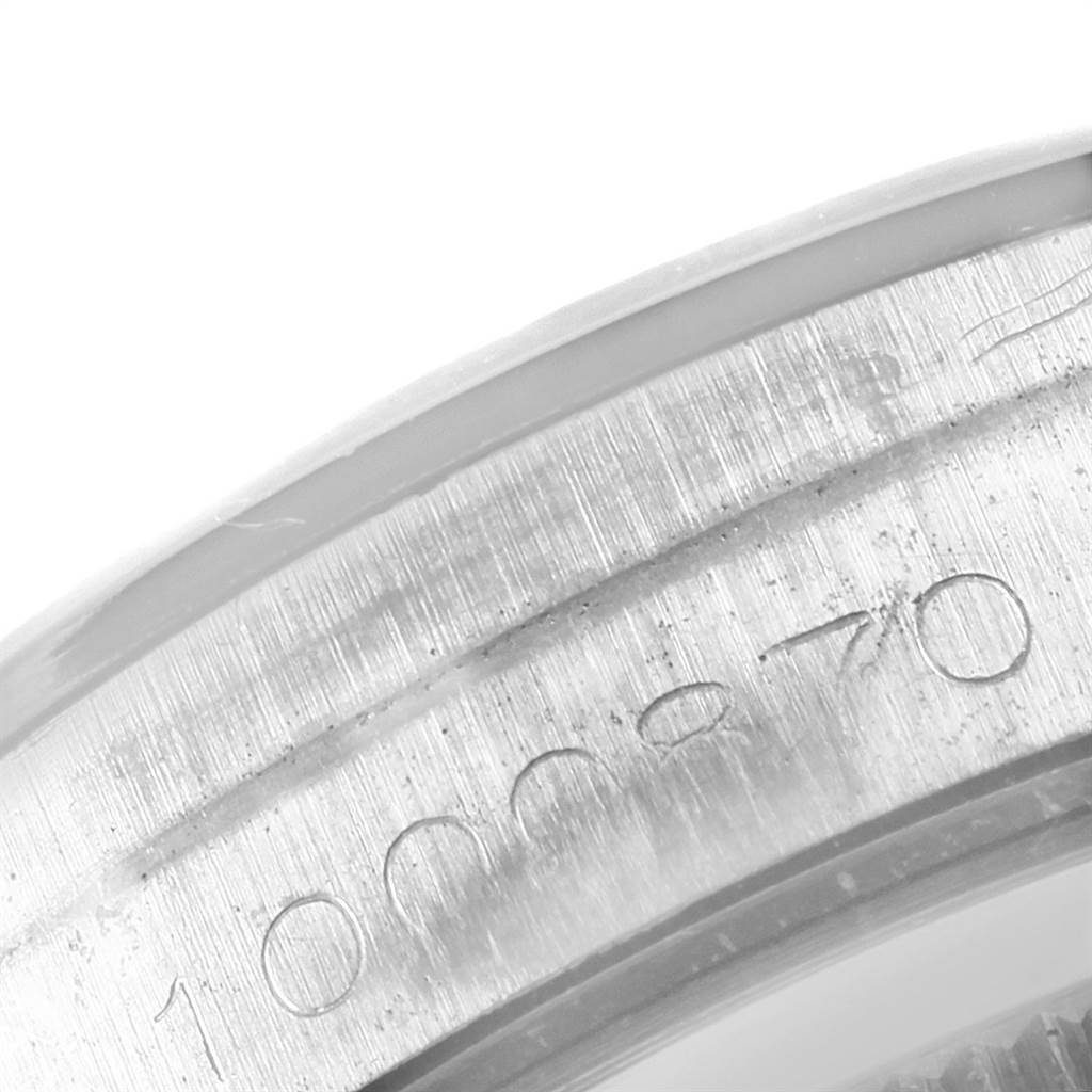 The image shows a close-up of the serial number inscribed on the case edge of a Vintage Collection Rolex watch.