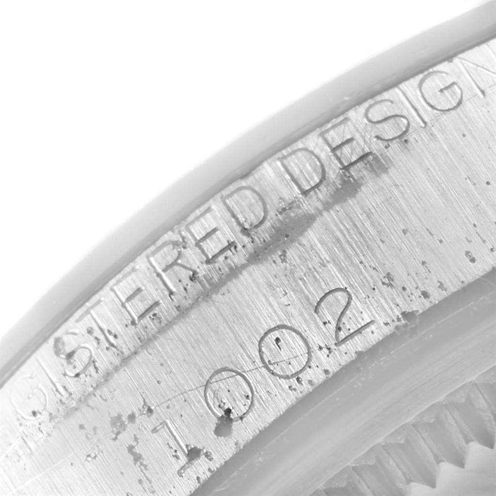 This image shows a close-up angle of the engraved text and numbers on the side of a Rolex Vintage Collection 1002 Men
s Stainless Steel Silver Dial 1002 Men
s Stainless Steel Silver Dial watch case.
