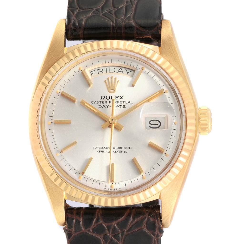 This is a front view of the Rolex Vintage Collection 1803 Men
s Yellow Gold Silver Dial 1803 Men
s Yellow Gold Silver Dial watch, showcasing the face with day and date indicators, along with partial leather straps.