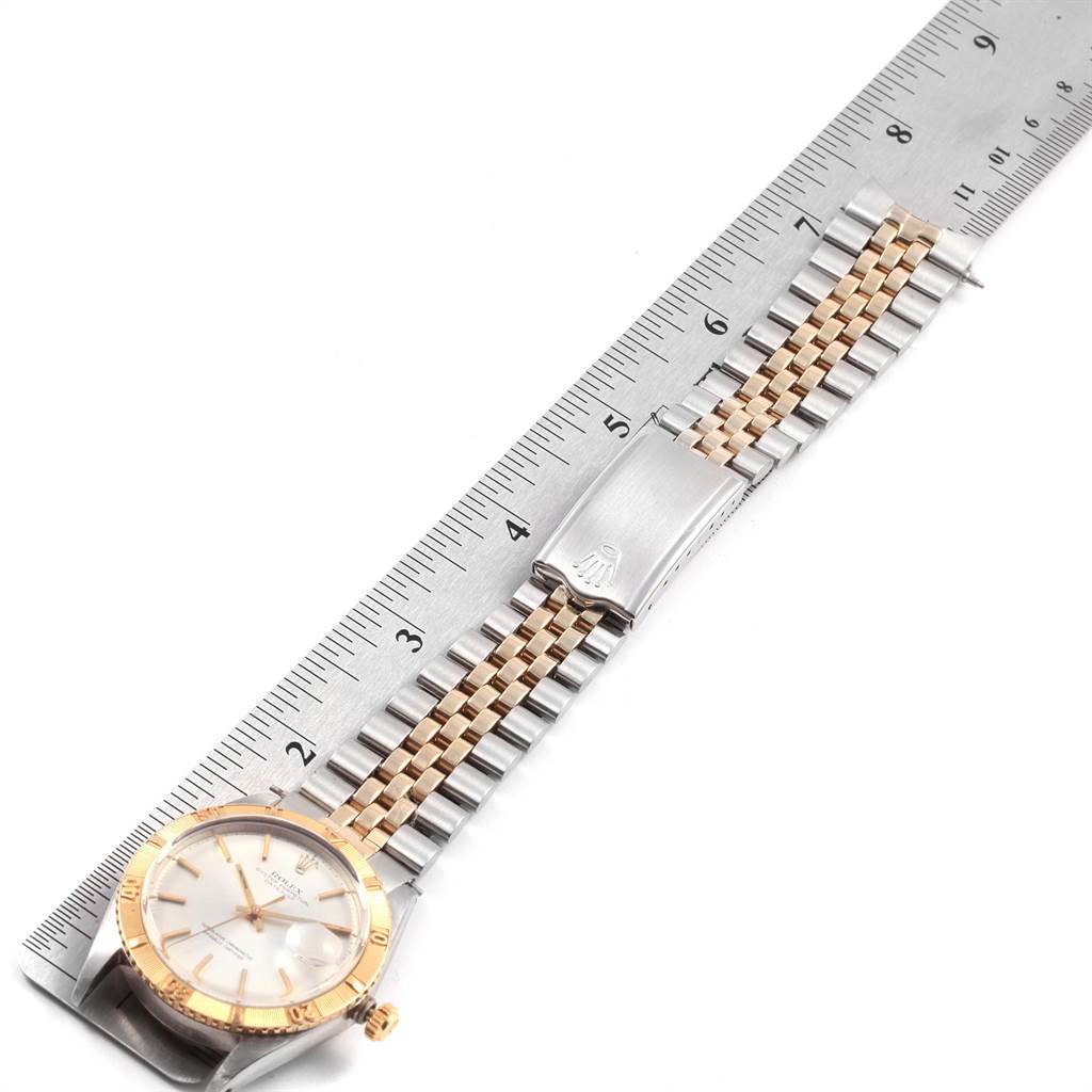 The image shows the Rolex Vintage Collection 1625 Men
s Steel and Gold (two tone) Silver Dial 1625 Men
s Steel and Gold (two tone) Silver Dial watch from a top-down angle, highlighting its bracelet and clasp next to a ruler.