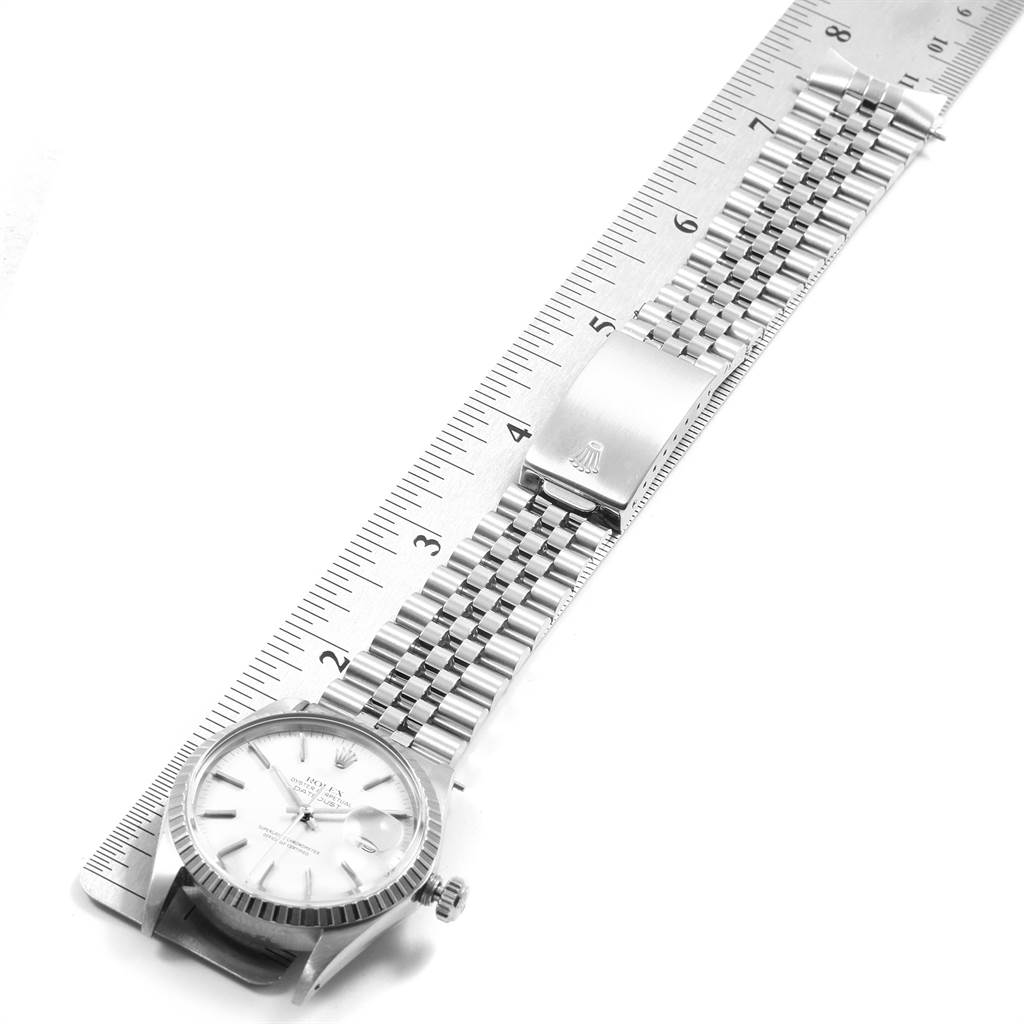 The image shows a top view of a Rolex Vintage Collection 16030 Men
s Stainless Steel White Dial 16030 Men
s Stainless Steel White Dial watch next to a ruler, displaying the face and bracelet.