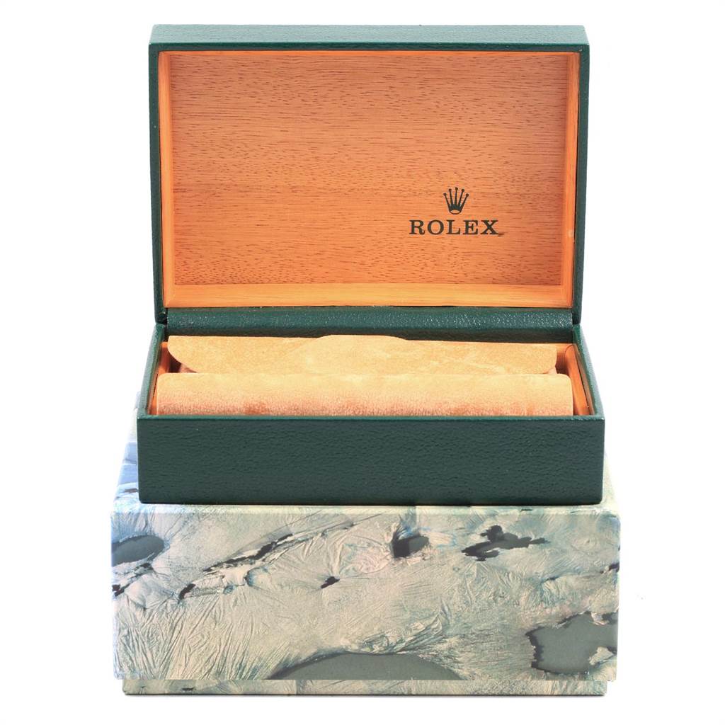 This image shows the open case for a Vintage Collection Rolex watch, displaying a green exterior and wooden interior.