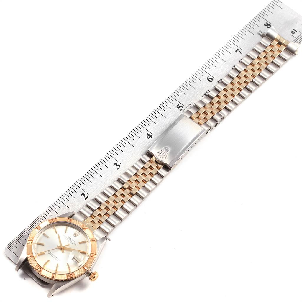 The image shows a Vintage Collection Rolex watch laid flat, displaying the face, crown, and bracelet against a ruler.