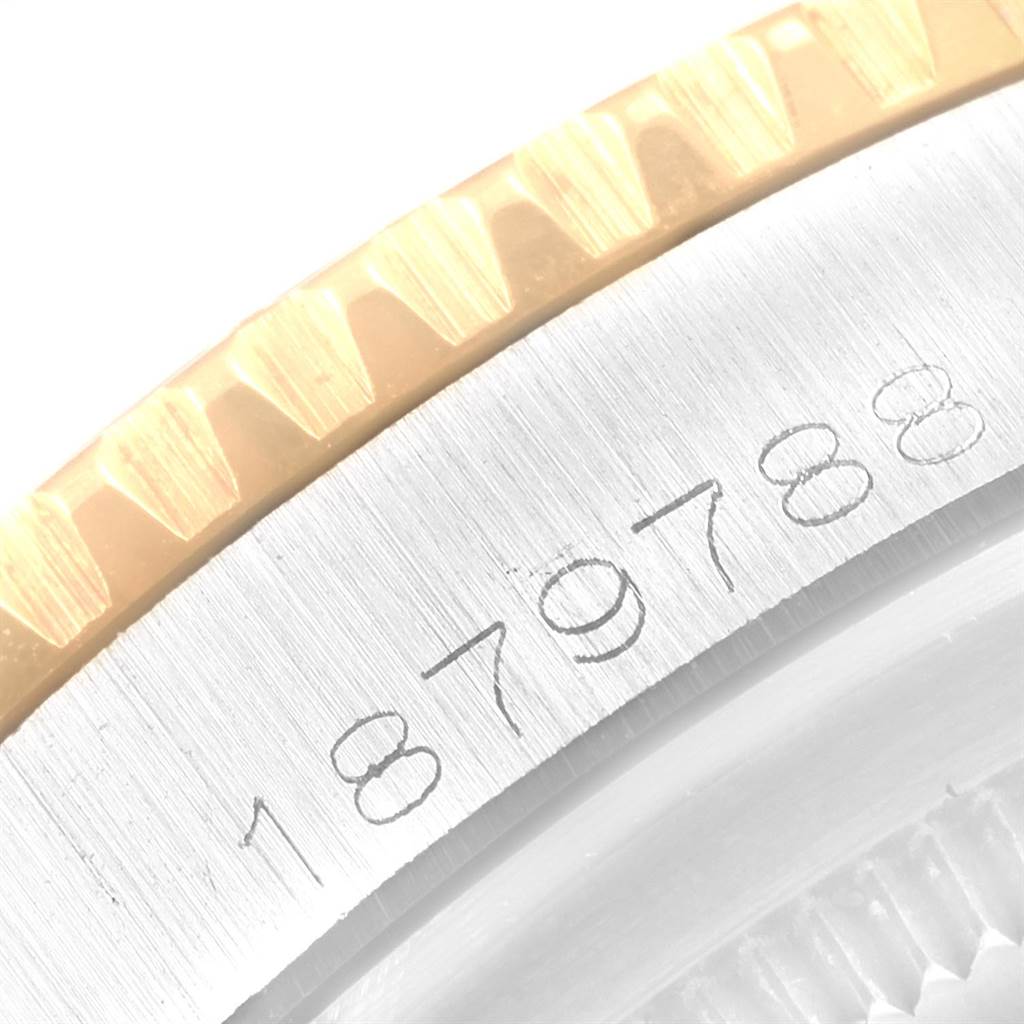 This close-up image shows the serial number and part of the bezel on a Rolex Vintage Collection 1625 Men
s Steel and Gold (two tone) Silver Dial 1625 Men
s Steel and Gold (two tone) Silver Dial watch.
