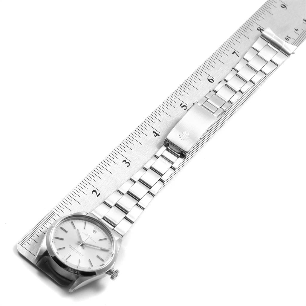 The Rolex Vintage Collection 1002 Men
s Stainless Steel Silver Dial 1002 Men
s Stainless Steel Silver Dial watch is shown flat with a silver metal strap and a clasp beside a ruler for measurement.