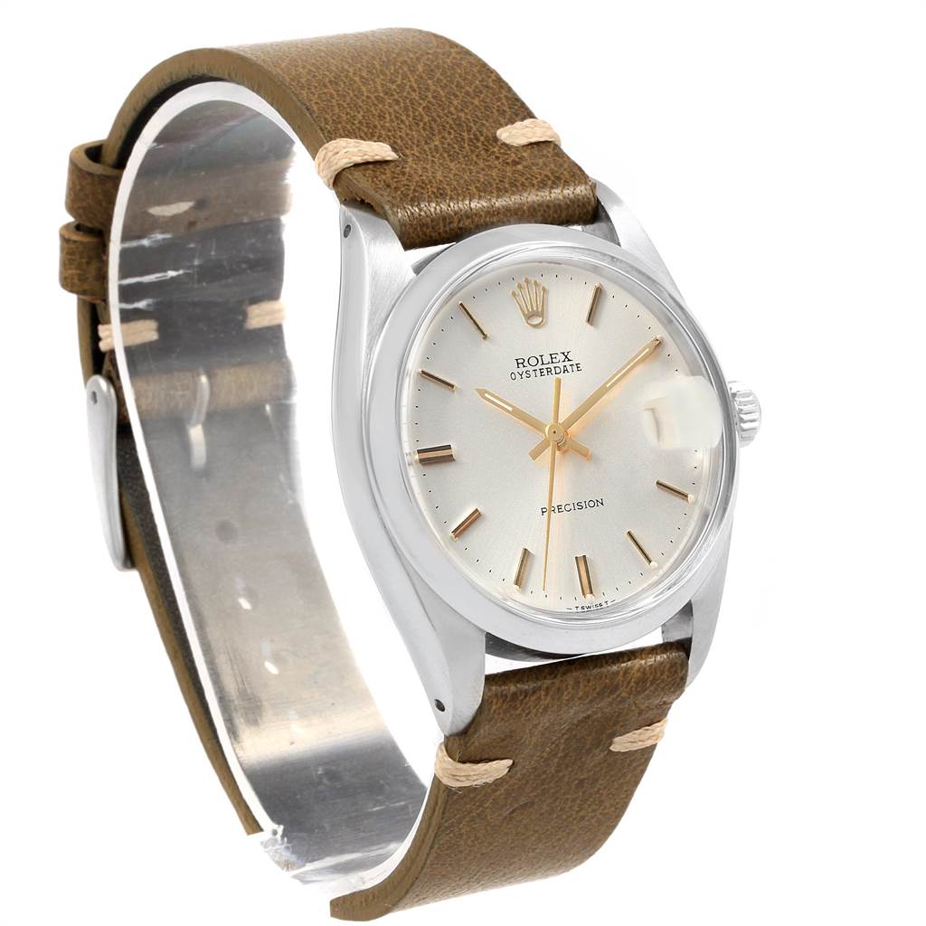 The image shows a three-quarters angle of a Rolex Vintage Collection 6694 Men
s Stainless Steel Silver Dial 6694 Men
s Stainless Steel Silver Dial watch with a brown leather strap and a silver dial.