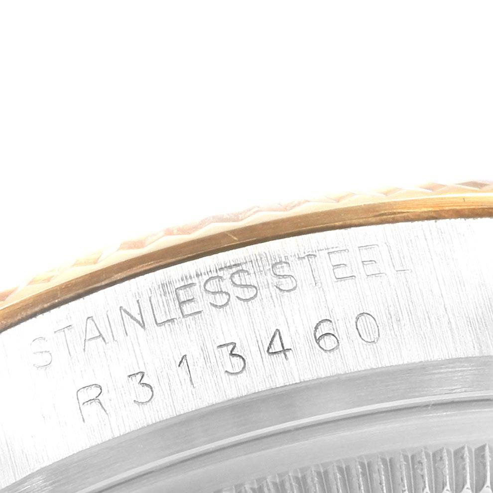 This is a close-up of the case back edge of the Rolex Vintage Collection 16013 Men's Stainless Steel Champagne Dial 16013 Men's Stainless Steel Champagne Dial watch, showing the serial number and "Stainless Steel" engraving.
